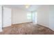 Cozy bedroom with a ceiling fan, plush carpeting, and a large window at 5712 Biscayne Ct # 205, New Port Richey, FL 34652