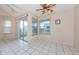 Dining room featuring tile floors, fan, and sliding glass door access to the balcony at 5712 Biscayne Ct # 205, New Port Richey, FL 34652