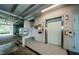 A communal elevator on a tiled floor is equipped with postal service and fire safety equipment at 5712 Biscayne Ct # 205, New Port Richey, FL 34652
