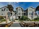 Elegant multi-story condominium building with well-maintained landscaping, lush greenery, and community dock access at 5712 Biscayne Ct # 205, New Port Richey, FL 34652
