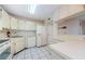 Well-lit kitchen with white appliances and ample countertop space offers a functional design at 5712 Biscayne Ct # 205, New Port Richey, FL 34652