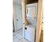 Convenient in-unit laundry closet with a stacked washer and dryer at 5712 Biscayne Ct # 205, New Port Richey, FL 34652