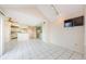 Open floorplan living room with mirrored wall and tile floors at 5712 Biscayne Ct # 205, New Port Richey, FL 34652