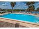Sparkling community pool surrounded by comfortable lounge chairs and stunning waterfront views at 5712 Biscayne Ct # 205, New Port Richey, FL 34652