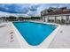 Community pool with tables and chairs; great for relaxing and enjoying the outdoors at 5712 Biscayne Ct # 205, New Port Richey, FL 34652