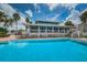 Inviting community pool with a clubhouse nearby, surrounded by lush landscaping and comfortable seating areas at 5712 Biscayne Ct # 205, New Port Richey, FL 34652