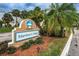 Community entrance sign at Mariner's Way, surrounded by lush landscaping and mature palm trees at 5712 Biscayne Ct # 205, New Port Richey, FL 34652