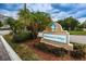 Mariner's Way community entrance sign with lush landscaping and swaying palm trees at 5712 Biscayne Ct # 205, New Port Richey, FL 34652