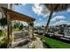 A covered wooden swing overlooks a pier and boats docked in the harbor at 5712 Biscayne Ct # 205, New Port Richey, FL 34652