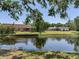 Beautiful backyard pond view with mature trees and lush landscaping surrounding the tranquil water at 6310 95Th E St, Bradenton, FL 34202