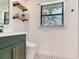 Bright bathroom featuring a tiled floor, floating shelves, and window with natural light at 6310 95Th E St, Bradenton, FL 34202