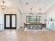Open dining room features modern lighting fixtures and a large window with natural light, perfect for Gathering gatherings at 6310 95Th E St, Bradenton, FL 34202