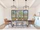Dining area showcasing a large table and chairs set under stylish pendant lights creating an elegant atmosphere at 6310 95Th E St, Bradenton, FL 34202