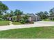 This lovely home features a three-car garage, beautiful landscaping, and a wrap around driveway at 6310 95Th E St, Bradenton, FL 34202