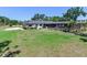 Expansive backyard featuring lush lawn and screened-in pool area, perfect for outdoor relaxation and enjoyment at 6310 95Th E St, Bradenton, FL 34202