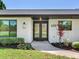 Close-up of the home's front entrance, highlighting the door, landscaping, and exterior finishes at 6310 95Th E St, Bradenton, FL 34202