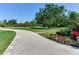View of the property entrance showcasing manicured landscaping and a winding driveway, adding to the curb appeal at 6310 95Th E St, Bradenton, FL 34202