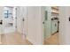 Bright hallway leads to bathroom with shower and laundry area at 6310 95Th E St, Bradenton, FL 34202
