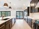 View of kitchen features island, stainless appliances, dark cabinets, and access to outdoor area at 6310 95Th E St, Bradenton, FL 34202