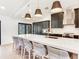 This kitchen features a large center island with seating, dark cabinets, and modern lighting at 6310 95Th E St, Bradenton, FL 34202
