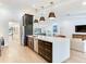 This modern kitchen has a spacious island, stainless steel appliances, and dark cabinetry at 6310 95Th E St, Bradenton, FL 34202