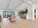 Open-concept living room and kitchen area with hardwood floors, featuring a bar and an inviting seating area at 6310 95Th E St, Bradenton, FL 34202
