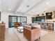 Bright living room features wood floors, beamed ceilings, and an open floorplan to the kitchen at 6310 95Th E St, Bradenton, FL 34202