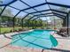Inviting pool with a screened enclosure and brick paver deck, perfect for relaxation at 6310 95Th E St, Bradenton, FL 34202