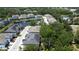 Aerial view of a community with a pond, mature trees and residential townhomes at 6617 Citrus Creek Ln, Tampa, FL 33625