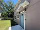 This home features a blue back door and a well-maintained yard with ample light at 6617 Citrus Creek Ln, Tampa, FL 33625