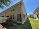 Exterior of the home with a screened porch and view of a green backyard at 6617 Citrus Creek Ln, Tampa, FL 33625
