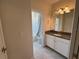 Bright bathroom featuring granite countertop and vanity with tile flooring and tub at 6617 Citrus Creek Ln, Tampa, FL 33625