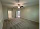 Carpeted bedroom with ensuite bathroom, bright lighting and neutral paint at 6617 Citrus Creek Ln, Tampa, FL 33625