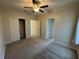 Comfortable bedroom featuring neutral carpet, ceiling fan, closet, and ensuite bathroom entry at 6617 Citrus Creek Ln, Tampa, FL 33625