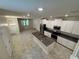 Open layout showcasing the kitchen with a center island, stainless appliances, and living area at 6617 Citrus Creek Ln, Tampa, FL 33625