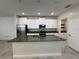 Kitchen boasts granite countertops, a central island with a sink, and modern stainless steel appliances at 6617 Citrus Creek Ln, Tampa, FL 33625