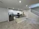 Open-concept kitchen with white cabinets, granite countertops, and stainless steel appliances at 6617 Citrus Creek Ln, Tampa, FL 33625