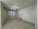 Bright living room featuring tile floors, a ceiling fan, and a shiplap accent wall with decorative shelving at 6617 Citrus Creek Ln, Tampa, FL 33625