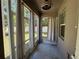 Enclosed back porch featuring ceiling fan and large windows overlooking the backyard at 6617 Citrus Creek Ln, Tampa, FL 33625