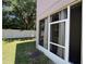 A screen door leading to the backyard and a view of the white privacy fence at 6617 Citrus Creek Ln, Tampa, FL 33625