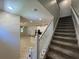 Carpeted staircase leading to the upper level, with views of the open-concept living spaces at 6617 Citrus Creek Ln, Tampa, FL 33625