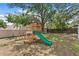 Playful backyard with a wooden playset featuring a slide, swings, and a small clubhouse for endless outdoor fun at 6712 Jennifer Dr, Temple Terrace, FL 33617