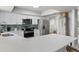 Kitchen featuring a large island with seating, white cabinets, and stainless steel appliances at 6712 Jennifer Dr, Temple Terrace, FL 33617