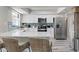 Modern kitchen with white cabinets, stainless steel appliances, and a large island with counter seating at 6712 Jennifer Dr, Temple Terrace, FL 33617