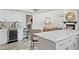Bright kitchen with white cabinetry, a wine cooler, and an island featuring bar stool seating at 6712 Jennifer Dr, Temple Terrace, FL 33617