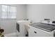 Functional laundry room includes a modern washer and dryer set, and a window that provides natural lighting at 6712 Jennifer Dr, Temple Terrace, FL 33617