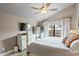 Cozy main bedroom with a large window, ceiling fan, and a comfortable, well-lit ambiance at 6712 Jennifer Dr, Temple Terrace, FL 33617