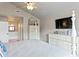 Bright main bedroom featuring dual dressers, a ceiling fan, and ensuite bathroom access at 6712 Jennifer Dr, Temple Terrace, FL 33617