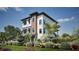 Stylish three-story home with a two-car garage, complemented by lush landscaping and palm trees at 721 Mandalay Ave, Clearwater Beach, FL 33767