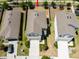 Aerial view showcasing the property's proximity to other homes, fenced yard and two car garage at 7486 Tuscan Bay Cir, Wesley Chapel, FL 33545